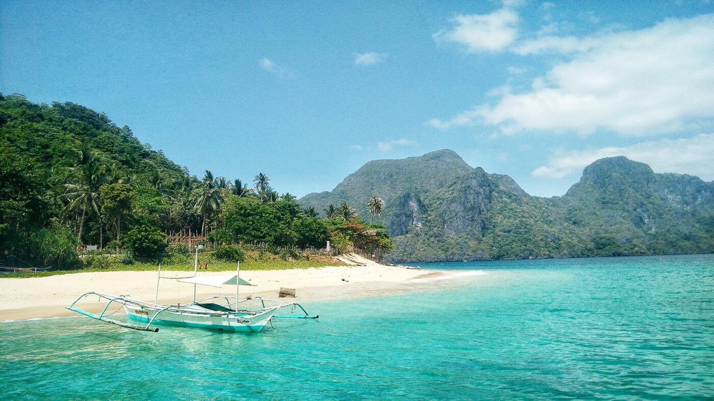 Paradisiac Island with a Traditional Banka Boat in Palawan, Philippines