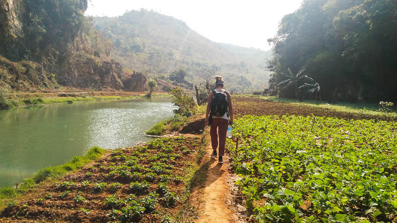 Friends Hiking through Farms and River in the Kalaw Hike in Myanmar