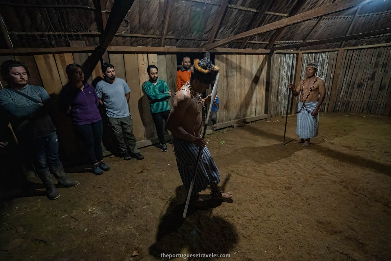 Jimmy dancing a tradicional Shuar dance and his father observing, on the Cueva de Los Tayos expedition.