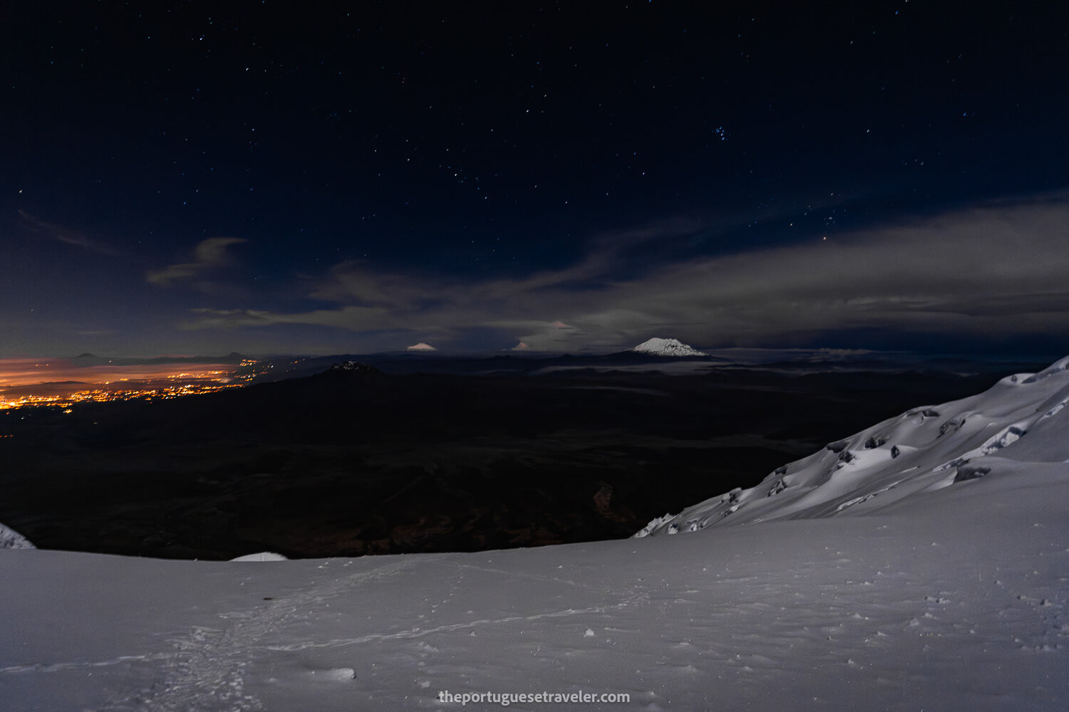 Illuminated Quito and the volcanoes Cayambe and Antisana