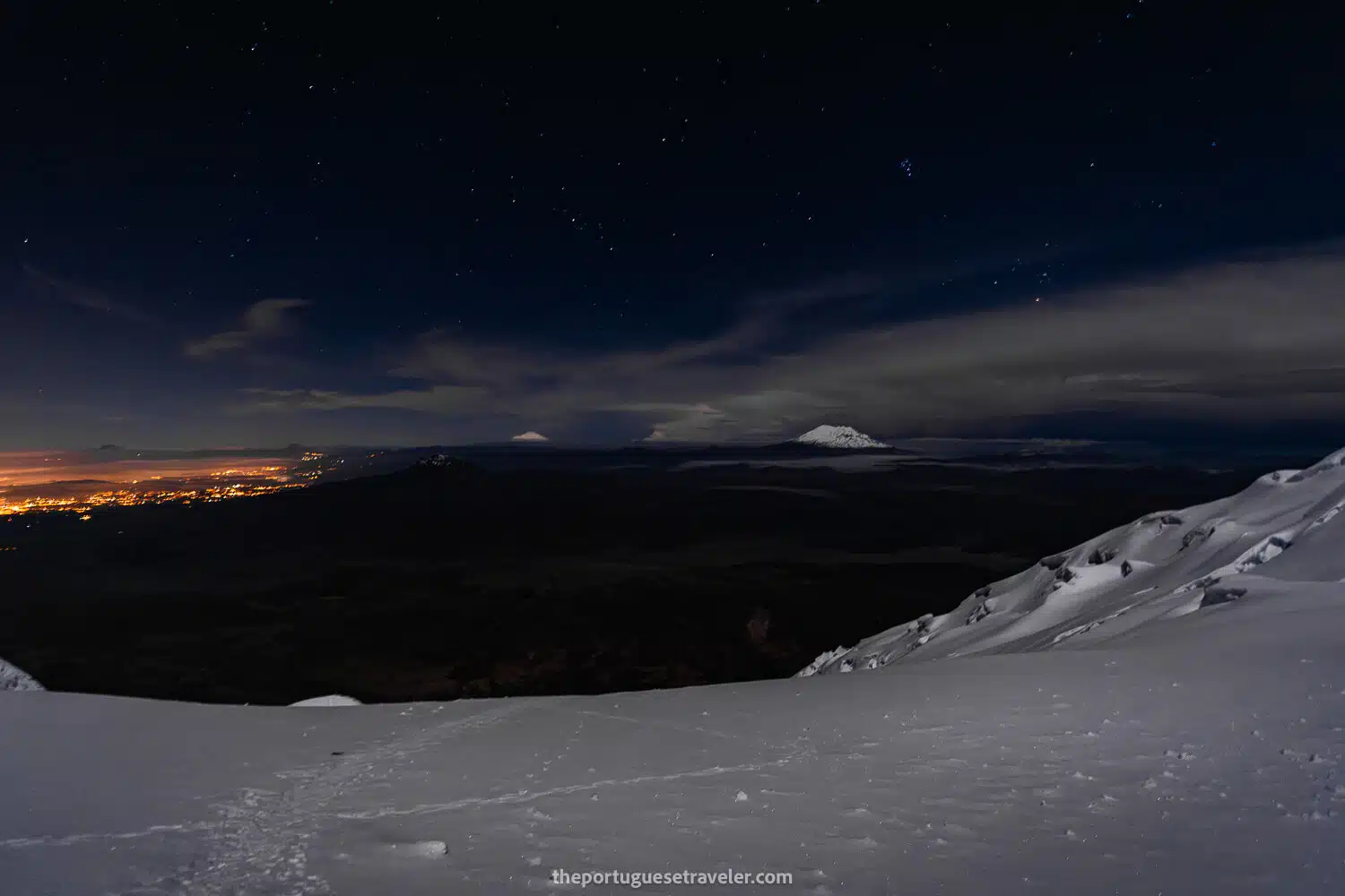 Illuminated Quito and the volcanoes Cayambe and Antisana