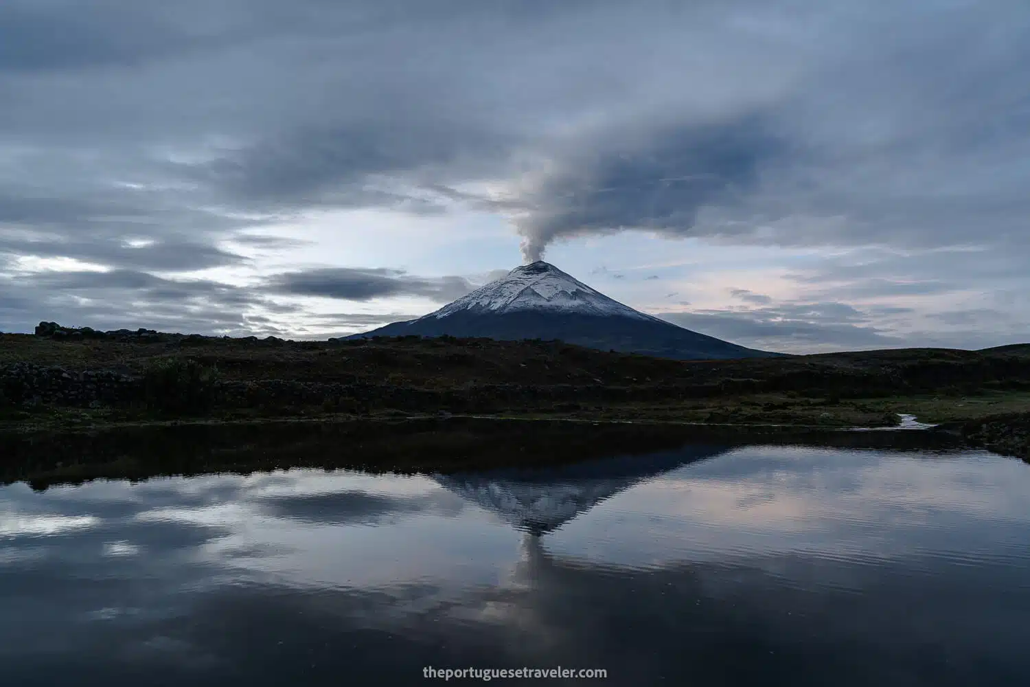 Cotopaxi Volcano erupting with reflection