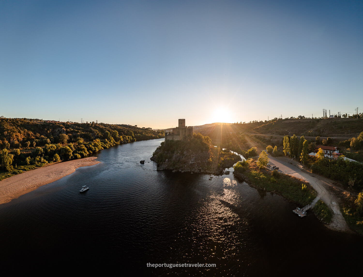 The Almourol Castle at Sunset and the Bar do Castelo, the parking lot and the dock of the castle on the right