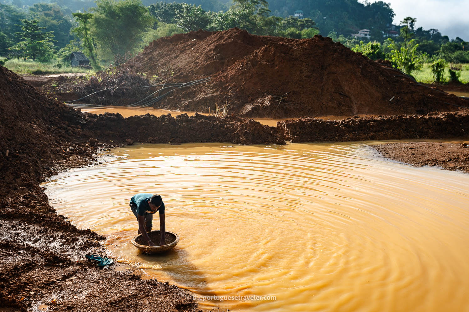 A miner in an open-cast mine searching for gems