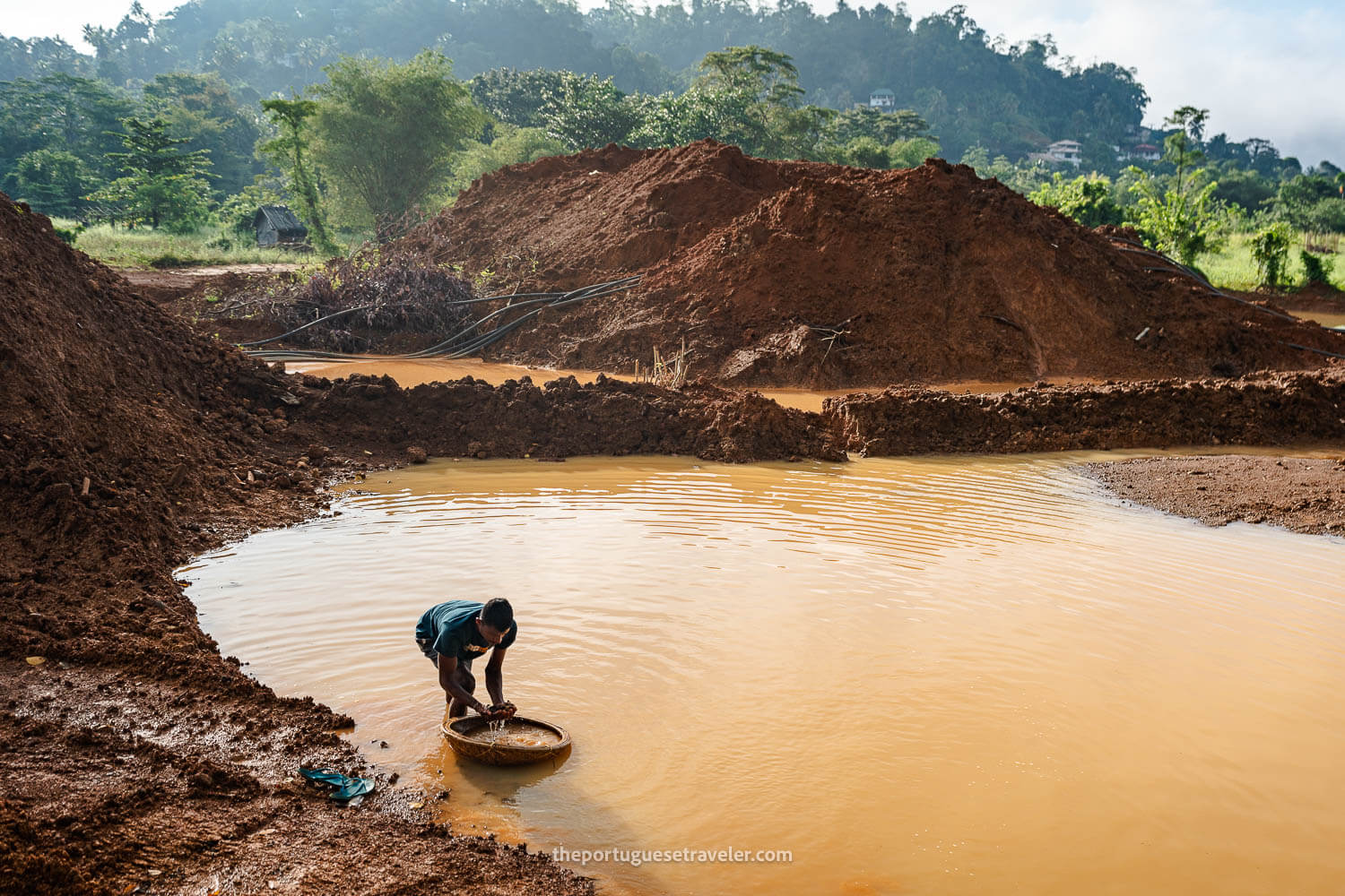 A miner in an open-cast mine searching for gems