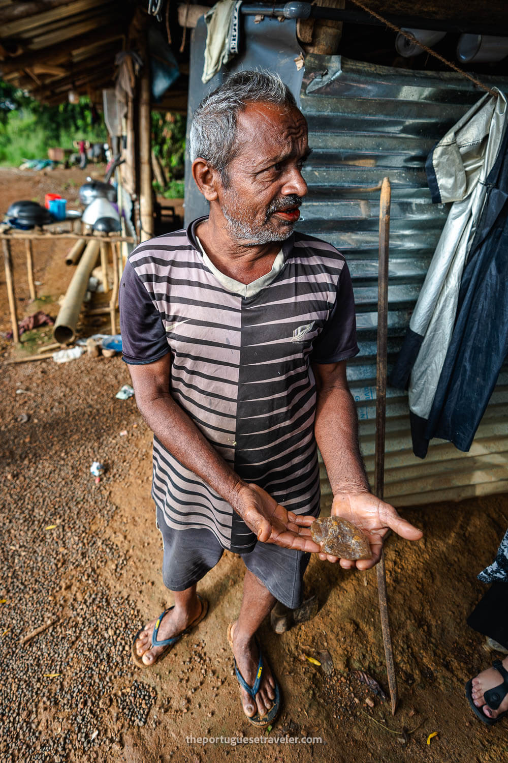 A miner showing his findings in the mine next to Ratnapura