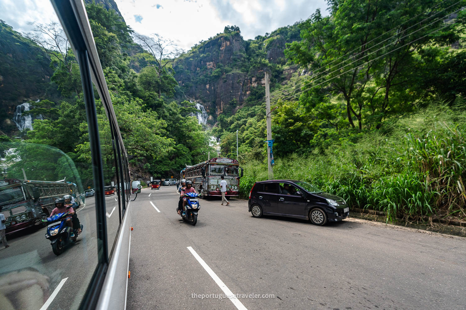 Our shuttle, a moto, a car, a tuktuk, a touristic bus next to the waterfall