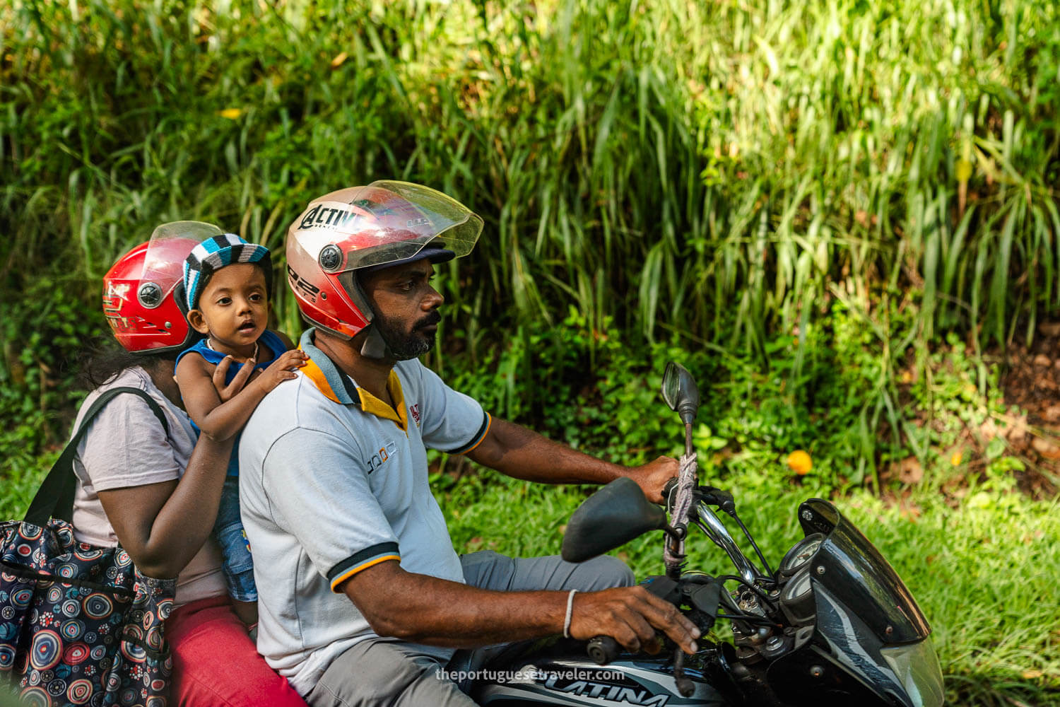 A family on a scooter on the road to the Sithulpawwa Rock Temple