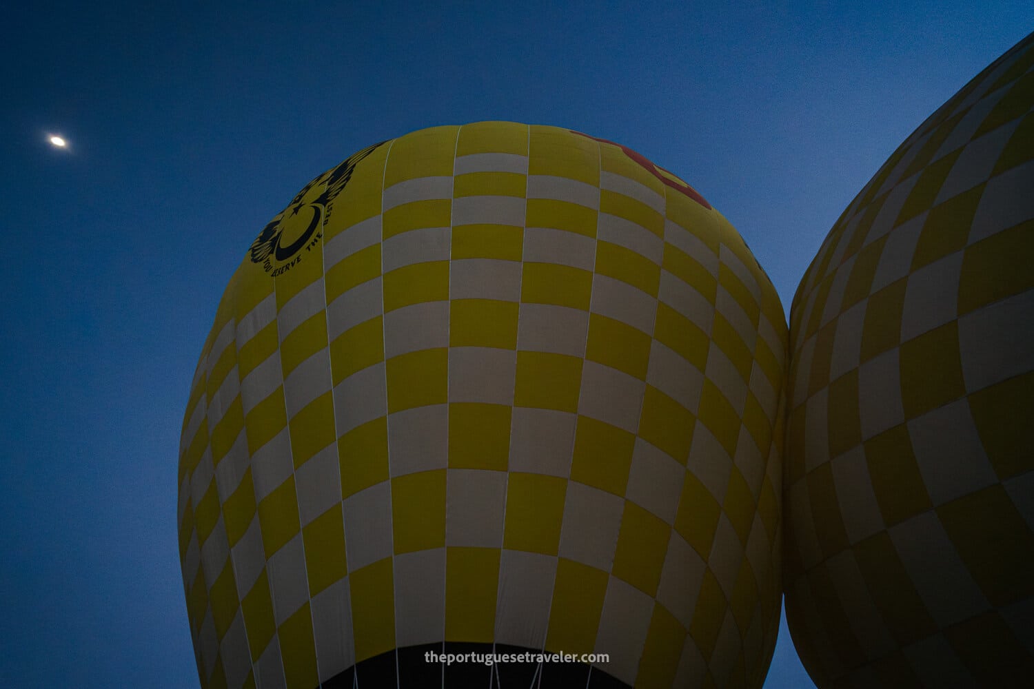 The two balloons crashing against each other while inflating