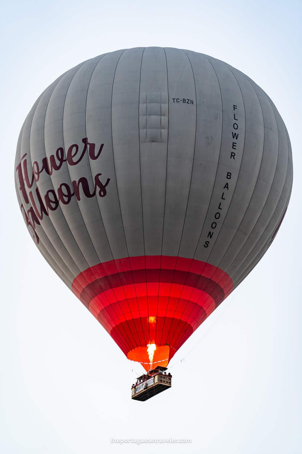 A hot air balloon flying in Cappadocia with a burst of fire