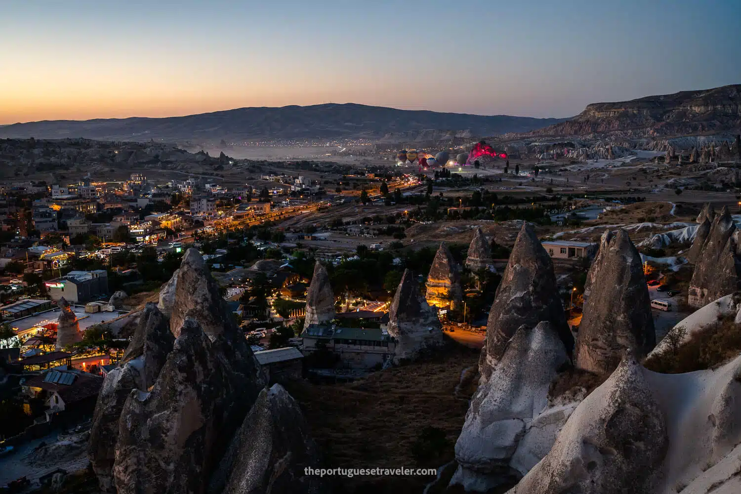 Göreme at dusk with a light show of hot air balloons